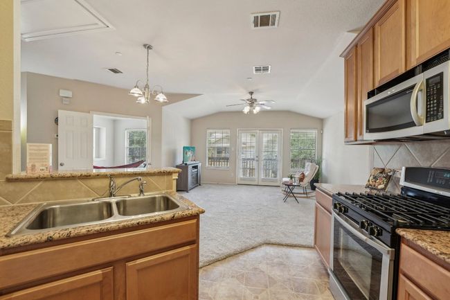 Stylish & Functional – Granite countertops, modern appliances, and ample cabinetry make this kitchen a joy to use. | Image 14