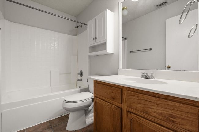 Full bathroom with ceramic tile floors, vanity, bathtub/shower combination | Image 20