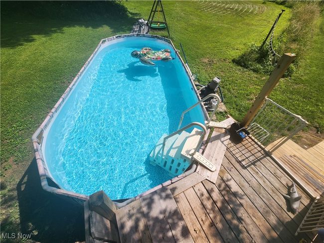 View of pool with a yard and a wooden deck | Image 35