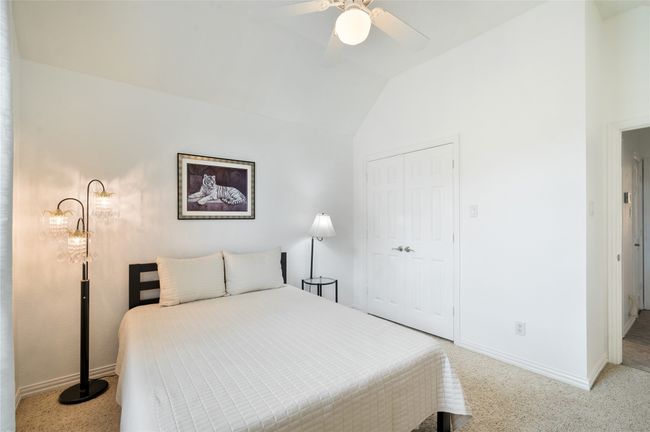 Bedroom with lofted ceiling, a closet, and a ceiling fan | Image 30