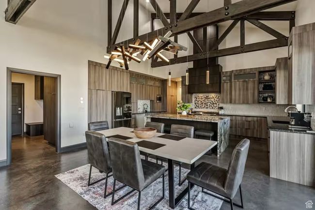 Kitchen featuring a center island, modern cabinets, a sink, and stainless steel fridge with ice dispenser | Image 9