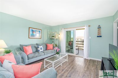 Open Living Room with Sliding Glass Door leading to Private Balcony overlooking Pool | Image 3