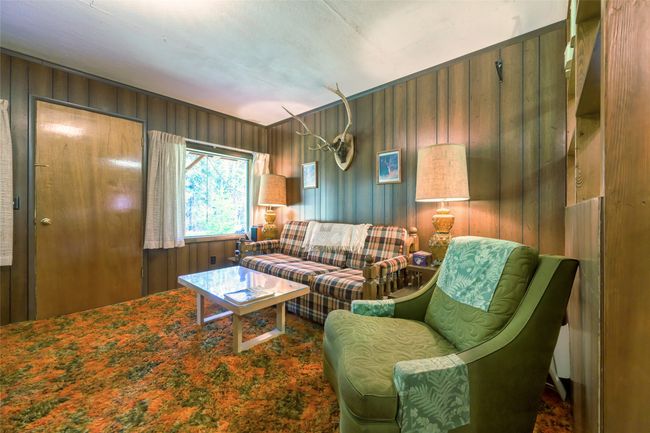 Living room featuring paneled walls | Image 21