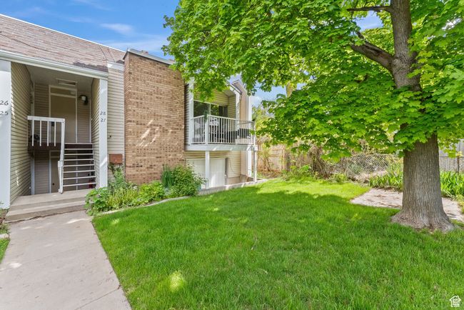 View of grassy yard with a balcony | Image 13