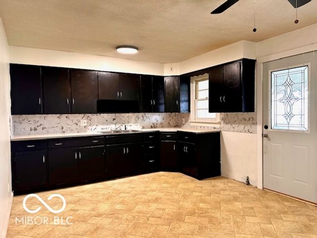 empty room featuring carpet floors, visible vents, baseboards, ceiling fan, and a textured ceiling | Image 13