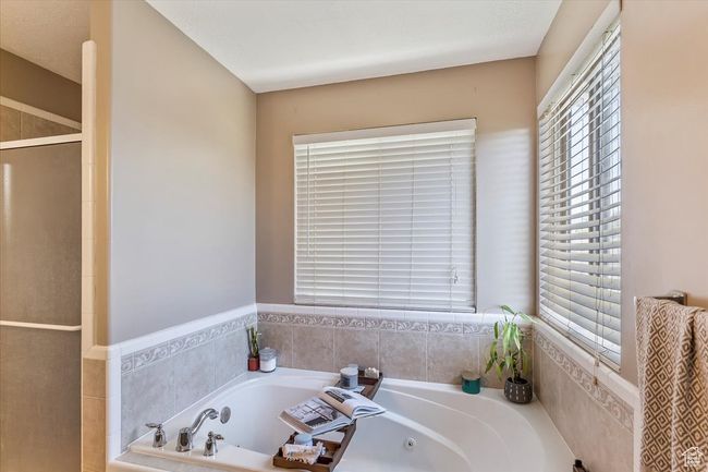 Full bath featuring a stall shower and a tub with jets | Image 15