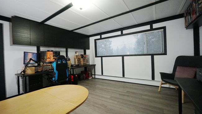 Cinema room with a baseboard heating unit and wood finished floors | Image 13