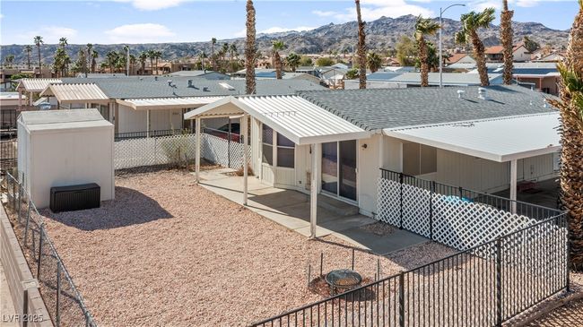 Back of property with a patio area, a mountain view, a residential view, and a fenced backyard | Image 58