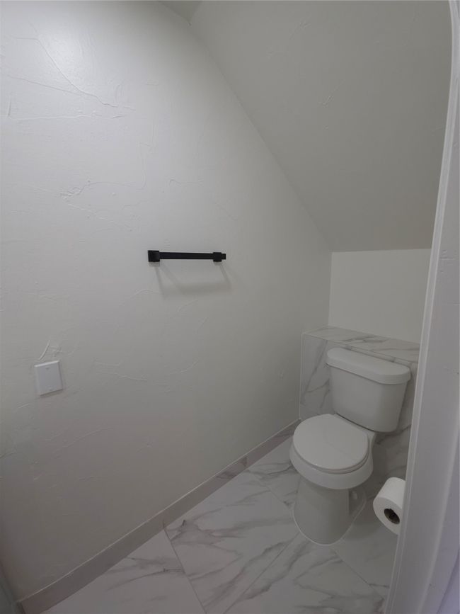 Bathroom featuring marble finish flooring and vaulted ceiling | Image 8