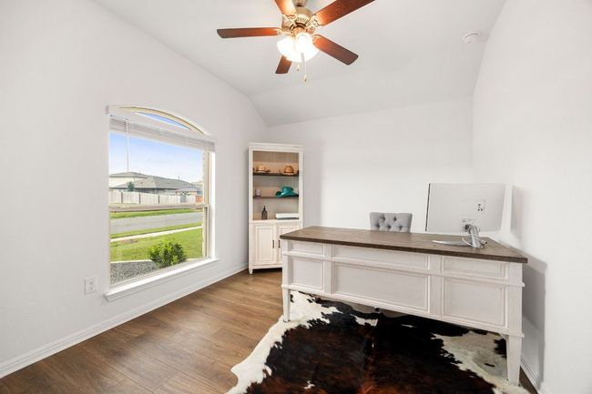 Office area with vaulted ceiling, wood finished floors, and a ceiling fan | Image 17