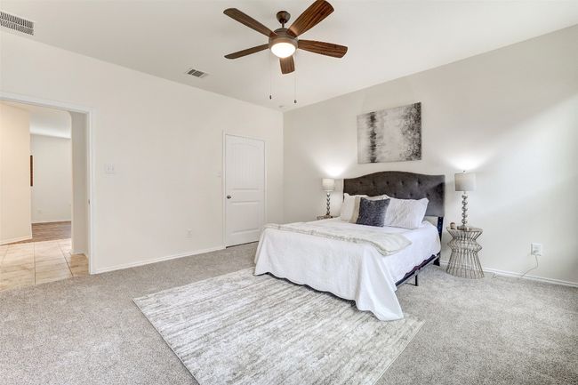 Primary Bedroom featuring light carpet and ceiling fan | Image 23