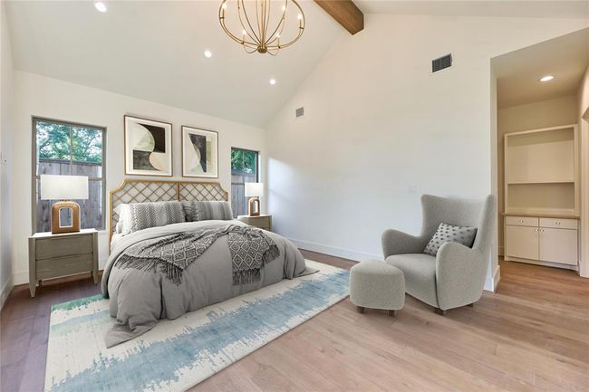 Bright and inviting primary suite featuring high ceilings with exposed wooden beams. Virtually staged. | Image 27