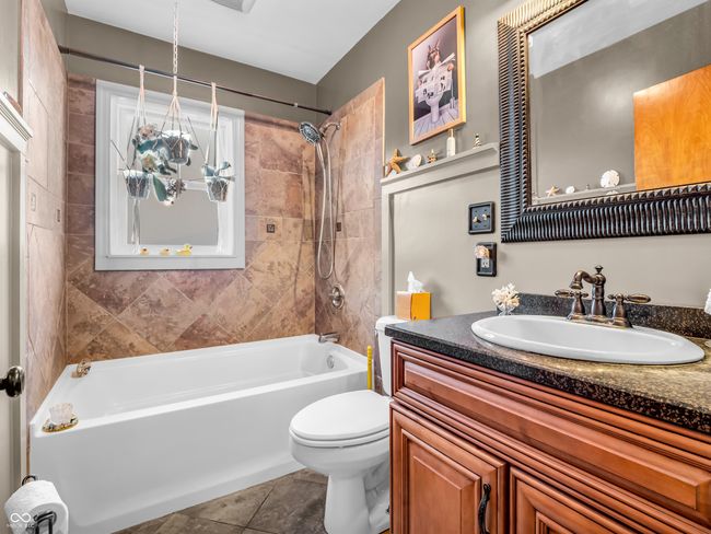 bathroom featuring tile patterned floors, toilet, shower / bathtub combination, and vanity | Image 23