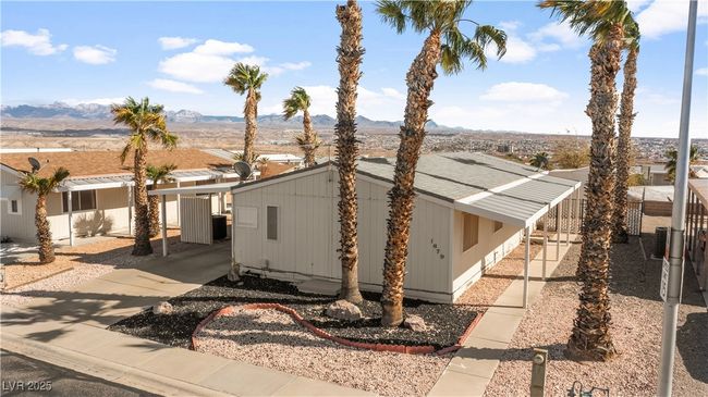 View of front of home with a carport, driveway, and a shingled roof | Image 65