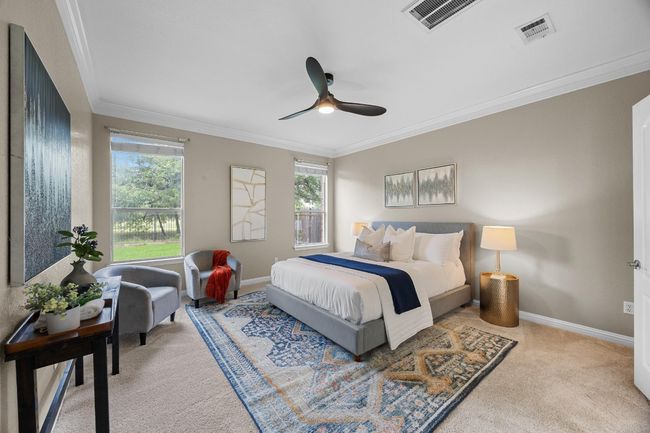 Primary bedroom featuring crown molding, multiple windows, and ceiling fan | Image 15
