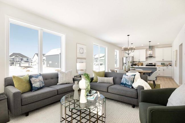 The open-concept design of the home is enhanced by strategically placed windows, allowing natural light to flood the space and create a bright, welcoming atmosphere. Photos are from previously built home; features and options will vary. | Image 6