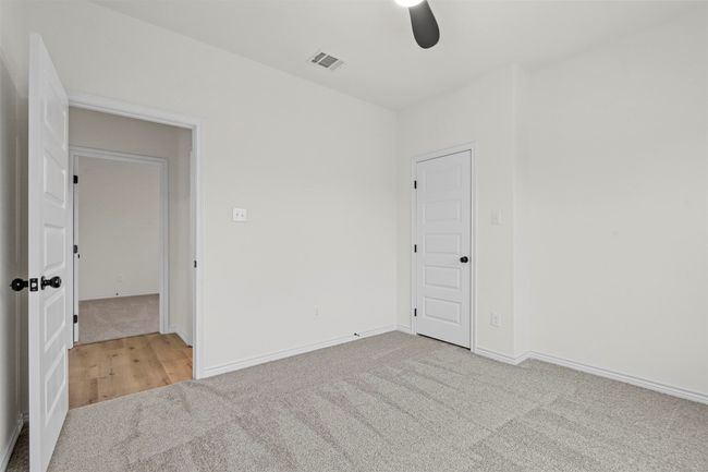 Unfurnished bedroom featuring ceiling fan and light colored carpet | Image 31