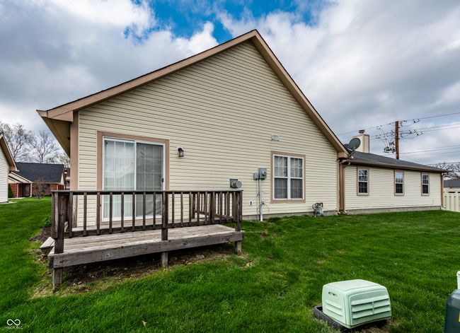 back of house with a wooden deck and a lawn | Image 5