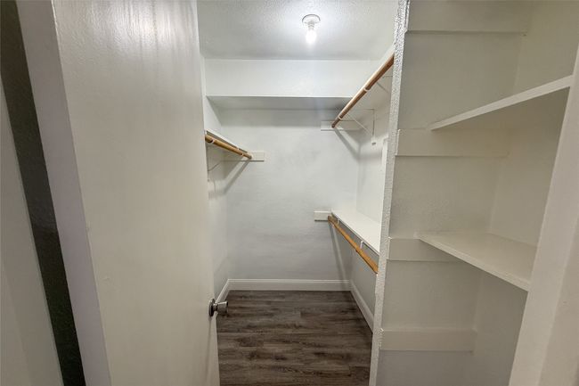 Spacious closet with wood finished floors | Image 22