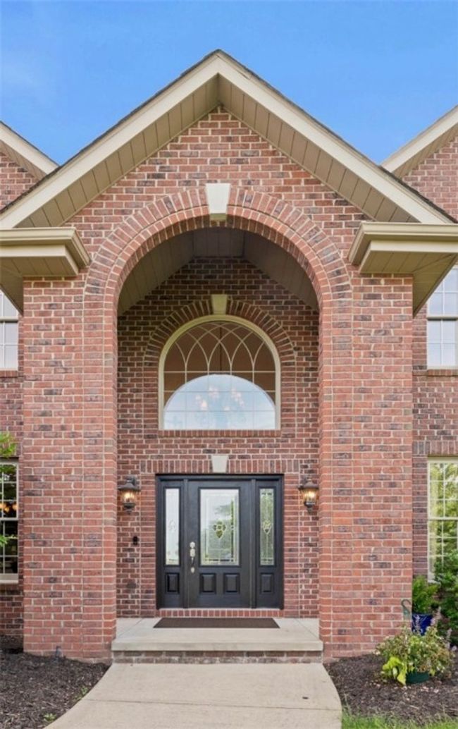 A covered front entry leads into the stunning two-story foyer. | Image 4