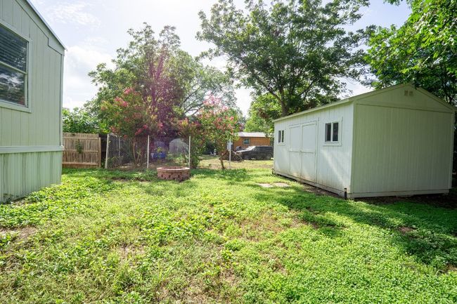 View of yard with a storage shed | Image 32