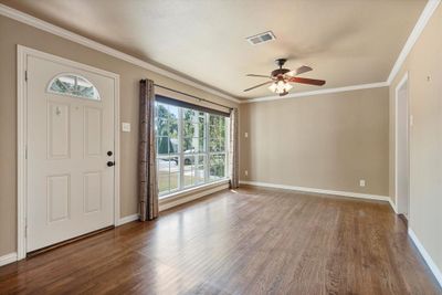 Foyer with ceiling fan, crown molding, and hardwood / wood-style floors | Image 3