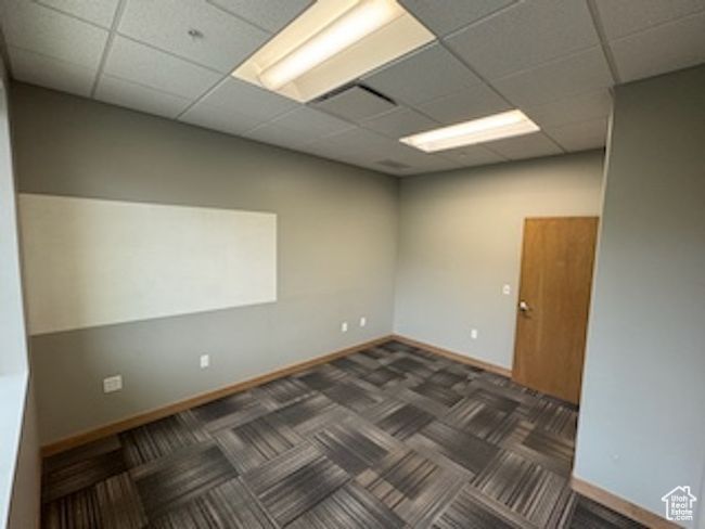 Unfurnished room featuring a paneled ceiling and dark carpet | Image 39