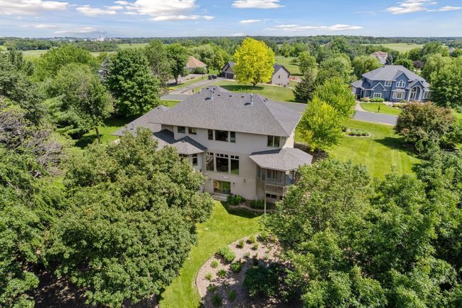 Serene treed and lake views! Fantastic neighborhood with privacy and large lots. | Image 56