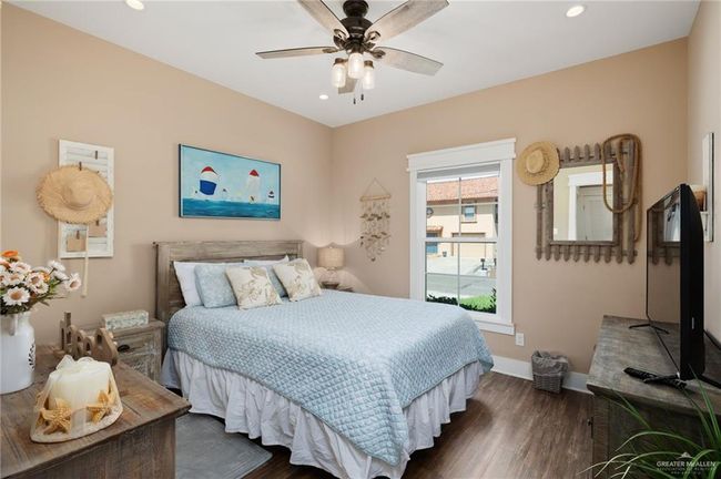 Bedroom featuring ceiling fan and dark hardwood / wood-style flooring | Image 9