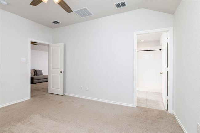 Unfurnished bedroom with carpet floors, a ceiling fan, and baseboards | Image 21