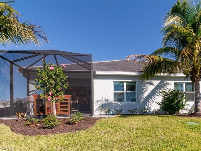 Back of property featuring a lanai and a lawn | Image 19