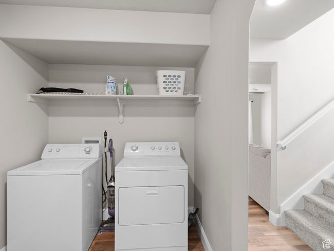 Washroom with light wood-style floors, washer and clothes dryer, laundry area, and baseboards | Image 25