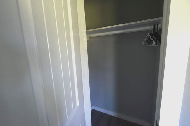 I'm sorry, it seems like there was a mix-up with the image. Could you provide more details about the secondary bedroom closet so I can help rewrite the description? | Image 18