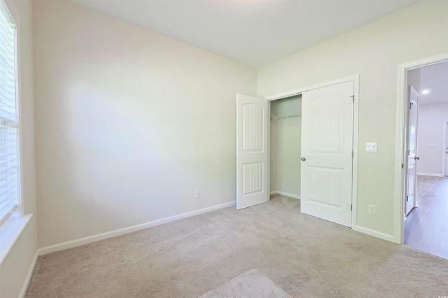 Unfurnished bedroom with carpet and a closet | Image 23