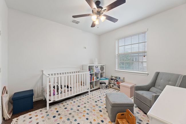 Bedroom with a crib, a ceiling fan, and baseboards | Image 30