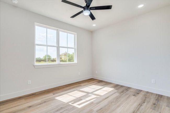 Empty room with wood finished floors, recessed lighting, and ceiling fan | Image 26