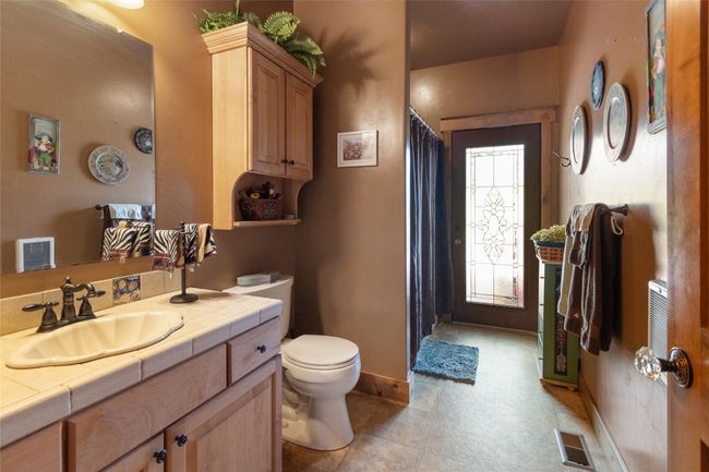 Bathroom with toilet, baseboards, vanity, and a shower with shower curtain | Image 31