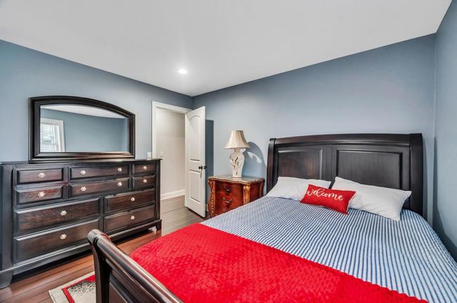 Bedroom with wood finished floors | Image 13