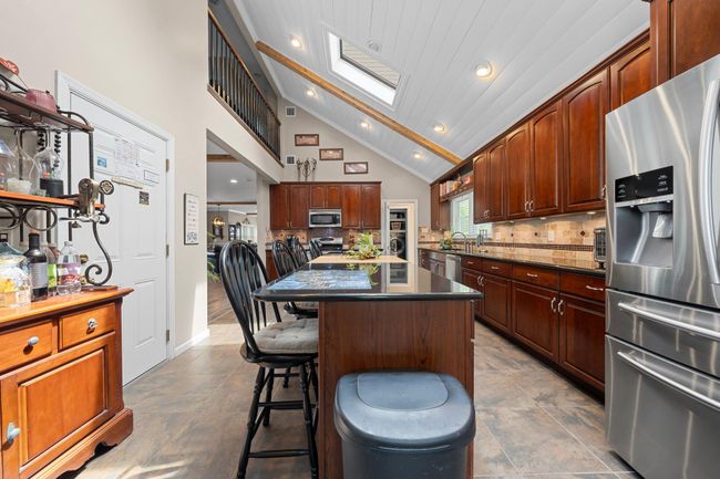 Living room with wood finished floors, a barn door, and recessed lighting | Image 21