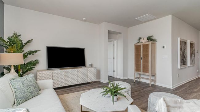 Living area featuring wood finished floors and baseboards | Image 6