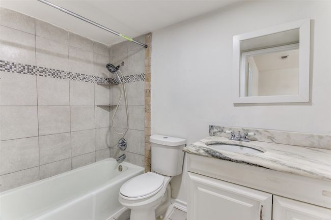 Bathroom featuring vanity and shower / bath combination | Image 13
