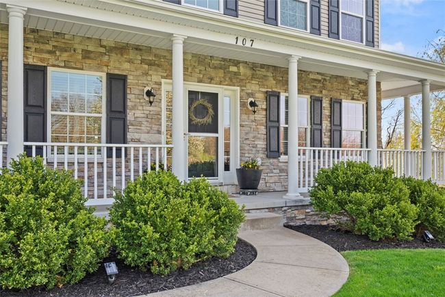 Grab your glass of iced tea and enjoy the view from your covered front porch. The wrap around deck leads all the way to the newer composite rear deck! | Image 6