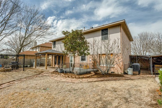 Back of property with a fenced backyard, central AC, a gazebo, a patio area, and brick siding | Image 24