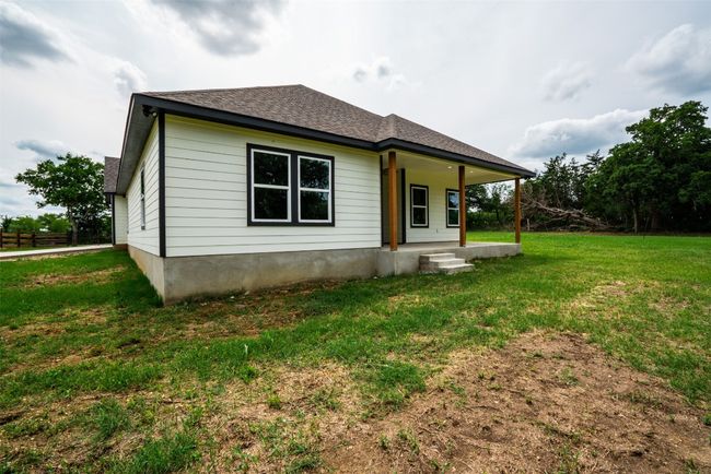 Back of house with a porch, a lawn, and roof with shingles | Image 37