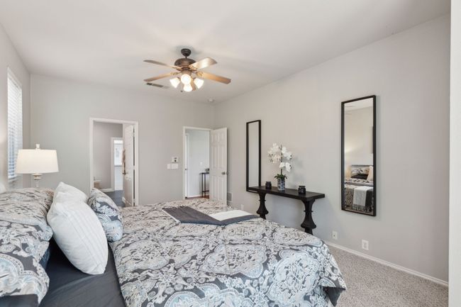 Bedroom with carpet flooring, baseboards, and a ceiling fan | Image 21
