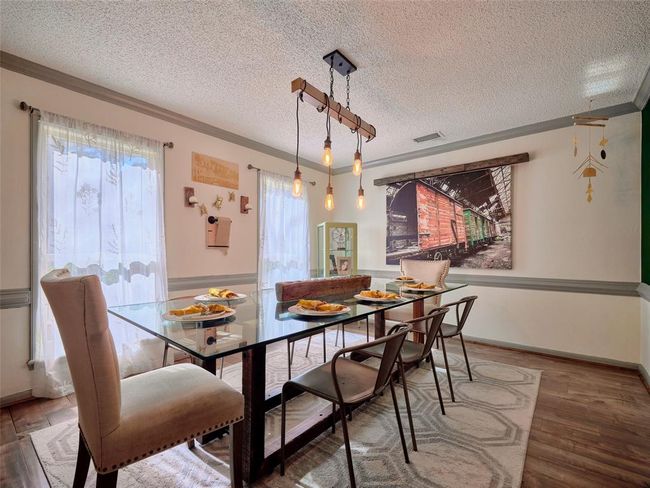 The generous dining room can easily accommodate an oversized dining set. | Image 13