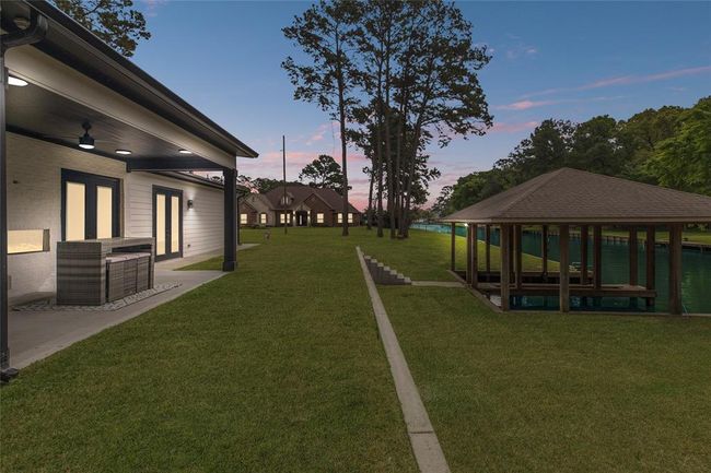Large back patio with a fireplace (no furniture) | Image 39