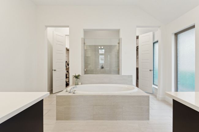 Bathroom with vanity, a bath, tile patterned flooring, plenty of natural light, and lofted ceiling | Image 19