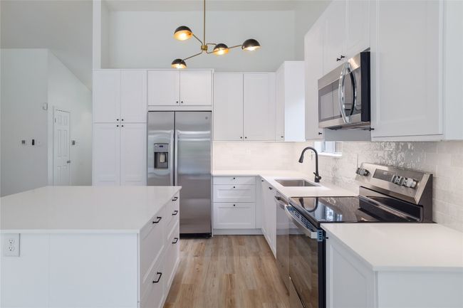 Chic light fixtures give this kitchen elegance. | Image 11