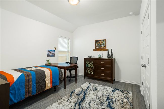 Bedroom featuring baseboards, lofted ceiling, and wood finished floors | Image 17